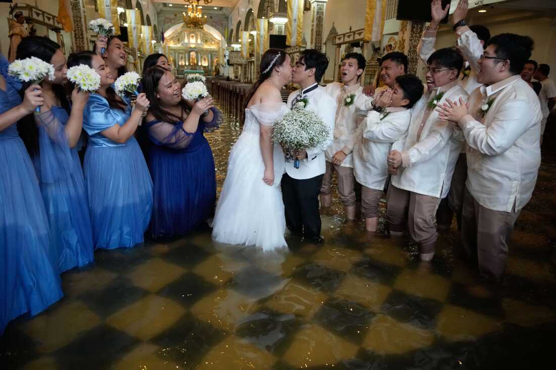 Wedding in the Flood The newlyweds share a kiss as guests cheer. The couple have been together for ten years. According to Verdillo, “This is just one of the struggles that we’ve overcome.” Malolos, Bulacan province, Philippines, 22 July 2025. Story: When Typhoon Wipha hit the Philippines and flooded Barasoain Church, Jade Rick Verdillo and Jamaica Aguilar faced a difficult decision: should they cancel their wedding or proceed with the marriage? The couple carried on despite high waters, a testament to love and resilience in the face of severe weather. Located on a delta, Bulacan province is vulnerable to more frequent and extreme floods caused by aging drainage systems, dredging projects, overextraction of groundwater, and climate change.