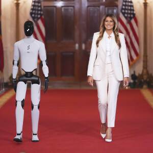 First lady Melania Trump arrivesaccompanied by a robotto attend the "Fostering the Future Together Global Coalition Summit," with other first spousesat the White HouseWednesdayMarch 252026in Washington.