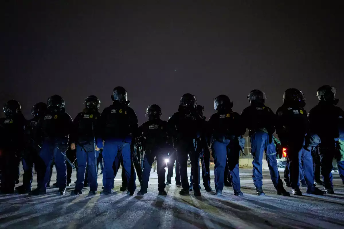 Federal immigration officers confront protesters outside Bishop Henry Whipple Federal Building, Jan. 15, 2026, in Minneapolis.