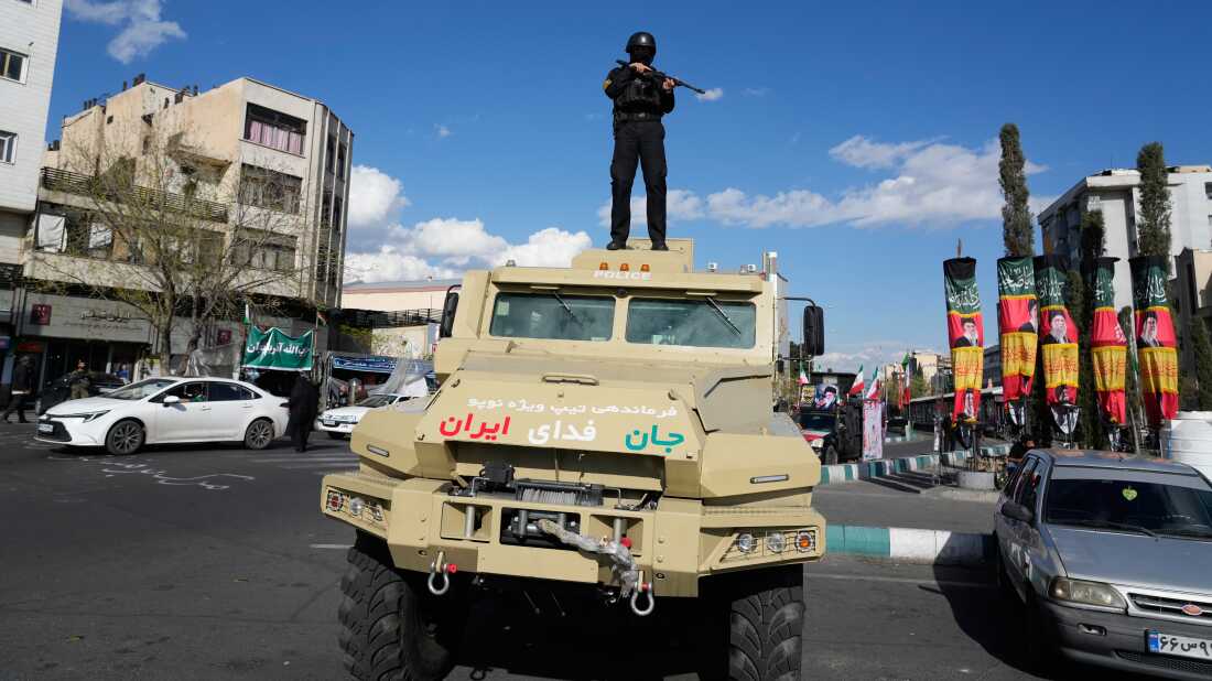A member of police special forces stands guard on top of a vehicle in downtown Tehran, Iran, Monday.