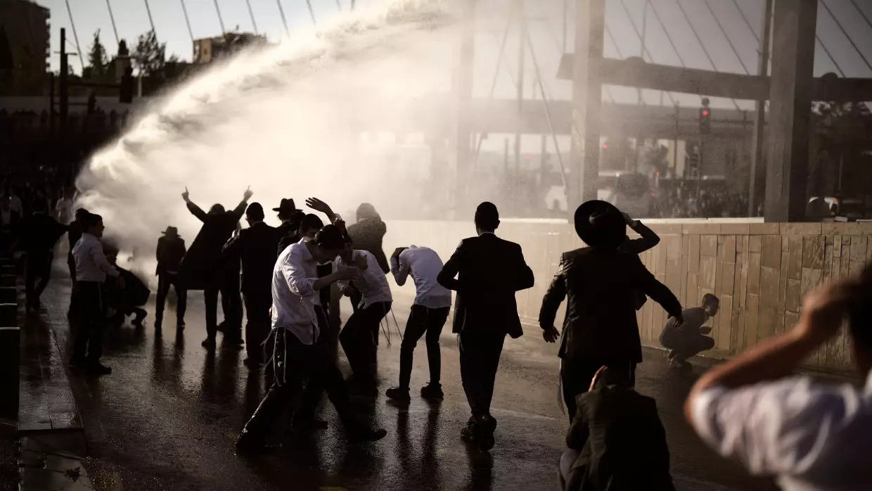 Police use water cannon to disperse ultra-Orthodox Jewish men blocking a street during a protest against the country's military draft in Jerusalem, April 29.