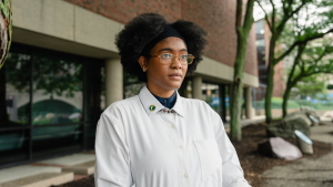 Netia McCray stands outside the Museum of Science, where she runs a STEM educational program for teens, in Boston, Mass. McCray, who developed long COVID near the beginning of the pandemic, was volunteering on a federal advisory committee on the disease before it was terminated. 