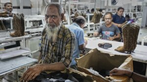 Workers at a manufacturing unit make leather footwear in Agra, India, on Monday.