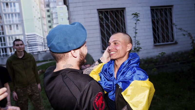 A Ukrainian soldier hugs his comrade after returning from captivity in a POW exchange in Ukraine, on Saturday.
