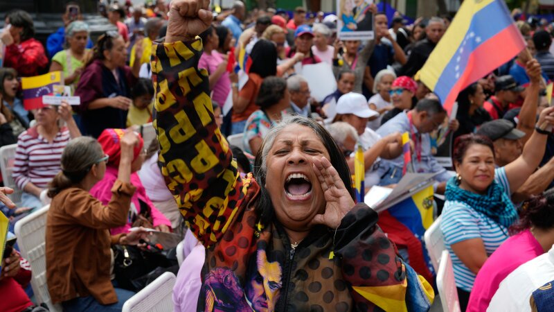 A woman screams during a government-organized event to watch former President Nicolas Maduro and first lady Cilia Flores appear in a New York court on a screen in Caracas, Venezuela, Thursday, March 26, 2026.