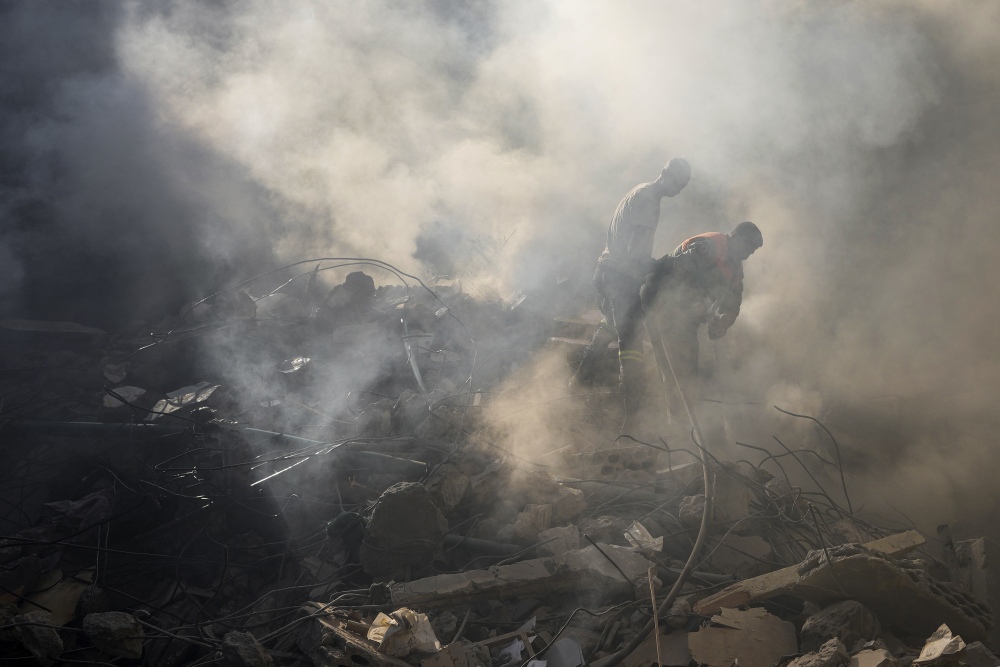 Rescue workers search for victims at the site of Thursday's Israeli airstrike in Beirut, Lebanon, on Friday. (AP)
