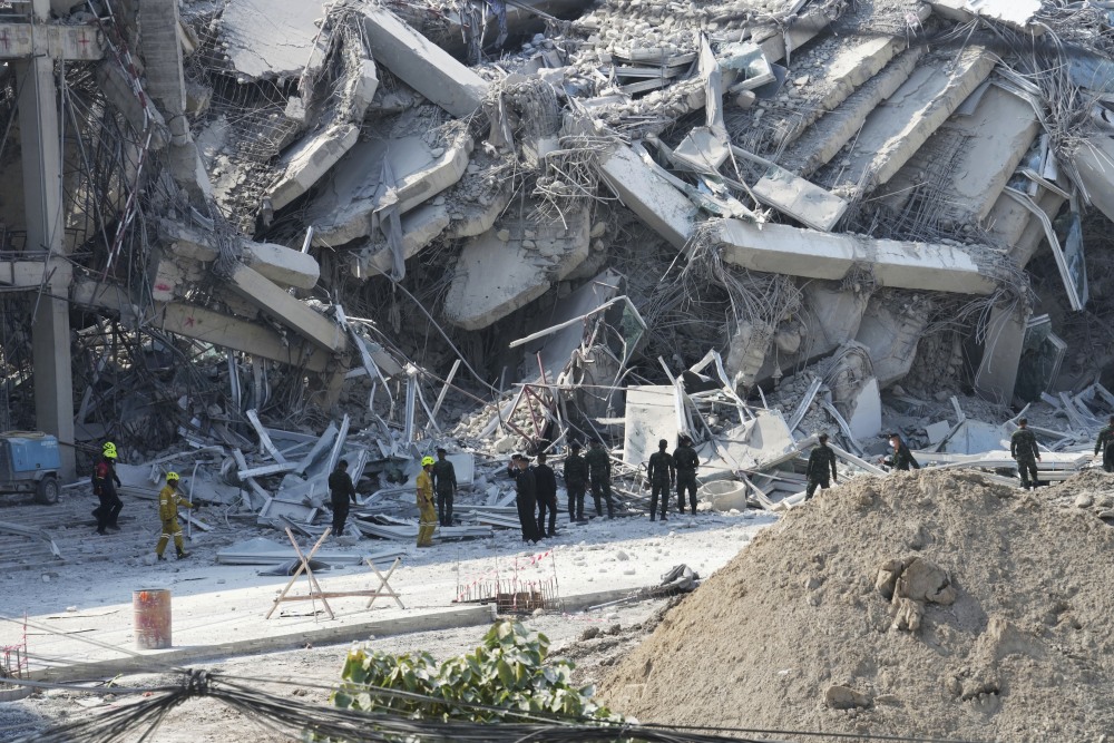 Rescuers work at the site of a high-rise building under construction that collapsed after a 7.7 magnitude earthquake in Bangkok on Friday. (AP)
