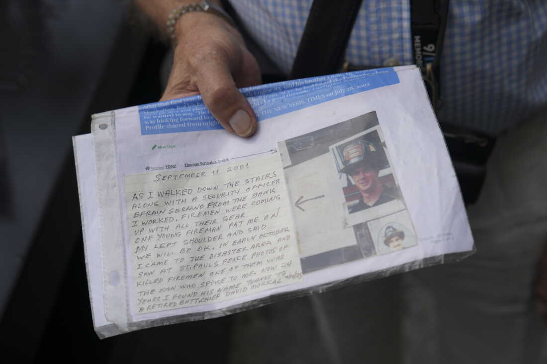 9/11 survivor George Mironis holds a photograph of a firefighter who died in the September 11 attacks and a note ahead of a memorial ceremony to commemorate the 25th anniversary of the September 11th terrorist attacks on the World Trade Center at the National 9/11 Memorial & Museum on September 11, 2026, in New York City.