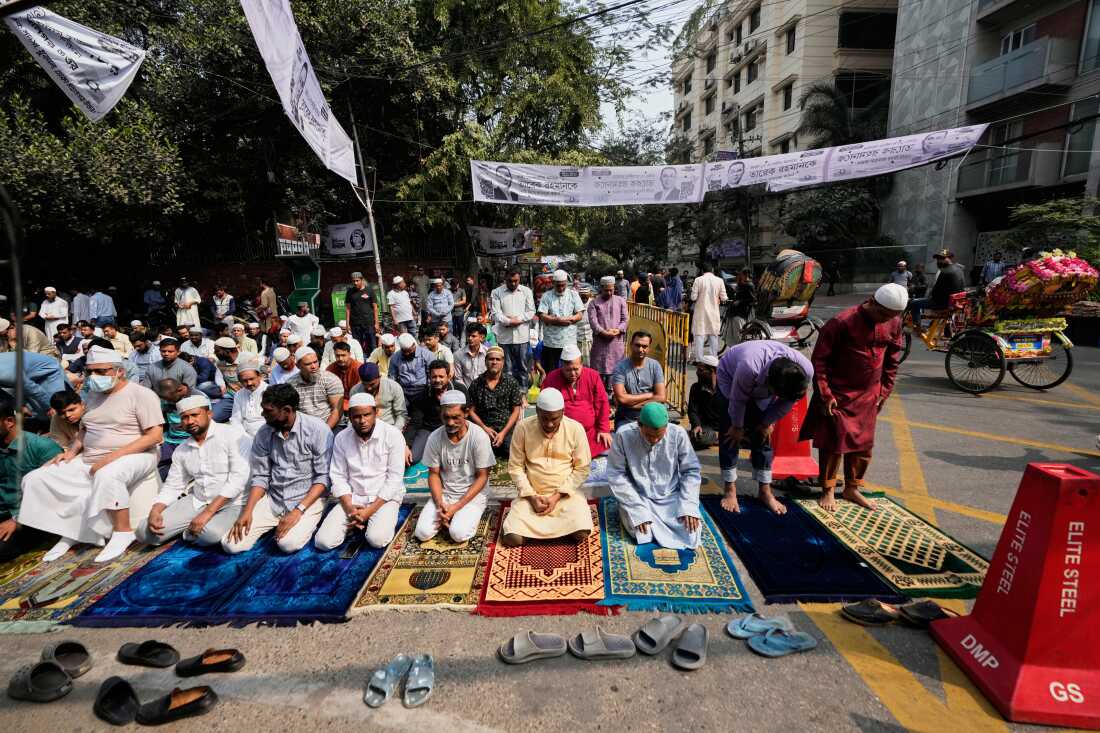 People offer Friday prayers on a road outside a mosque a day after the national parliamentary election in Dhaka, Bangladesh, Friday, Feb. 13, 2026.