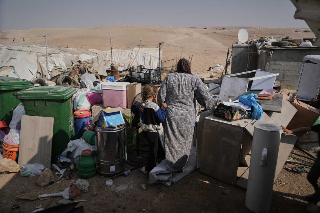 Members of the Hamamdeh family gather their belongings after Israeli authorities demolished their home in the West Bank village of Masafer Yatta Wednesday.