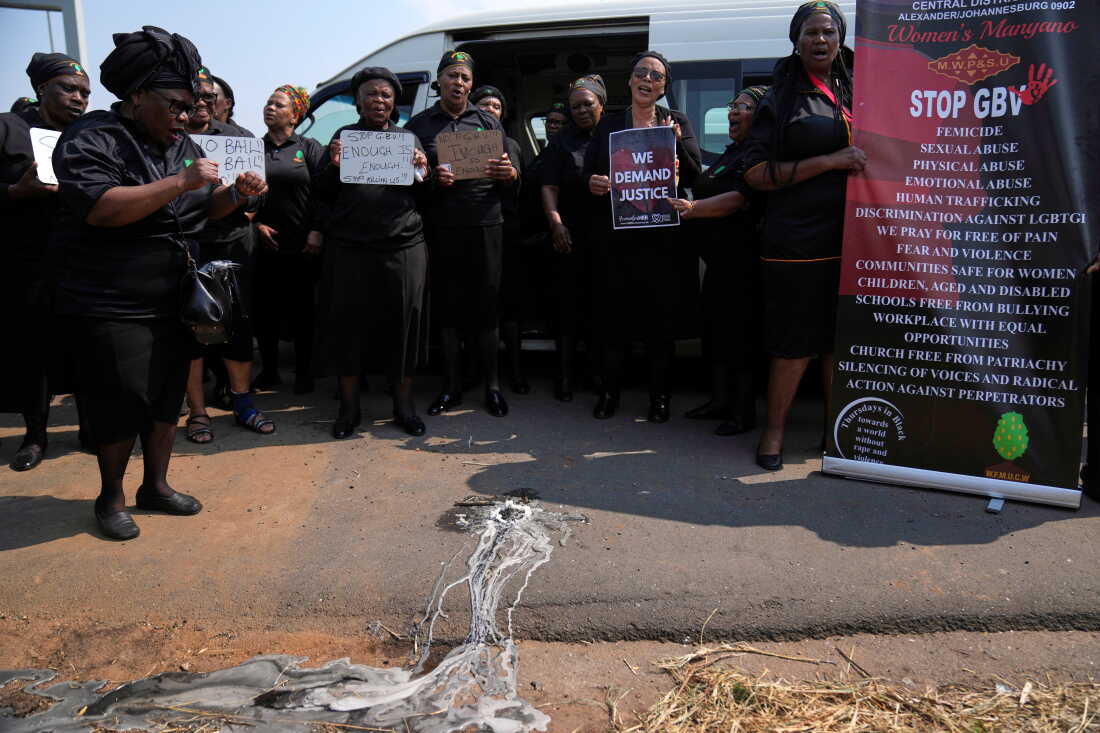 Members of a women's church group sing next to a melted candle as they pay their respects at the site where the body of a woman was discovered the previous week, in Kempton Park, South Africa, east of Johannesburg, Thursday, Sept. 17, 2026.