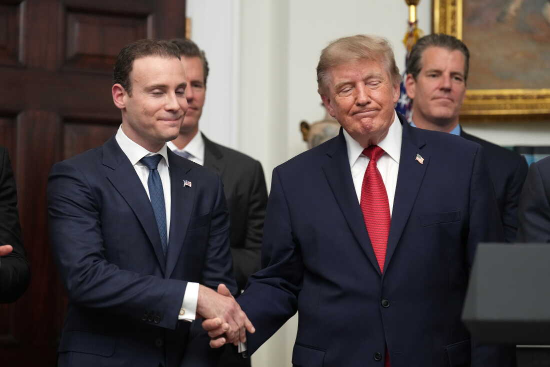 President Donald Trump shakes hands with Commodity Futures Trading Commission (CFTC) Chairman Michael Selig during a meeting with technology leaders in the Roosevelt Room of the White House, Wednesday, Aug. 19, 2026, in Washington. (AP Photo/Jacquelyn Martin)