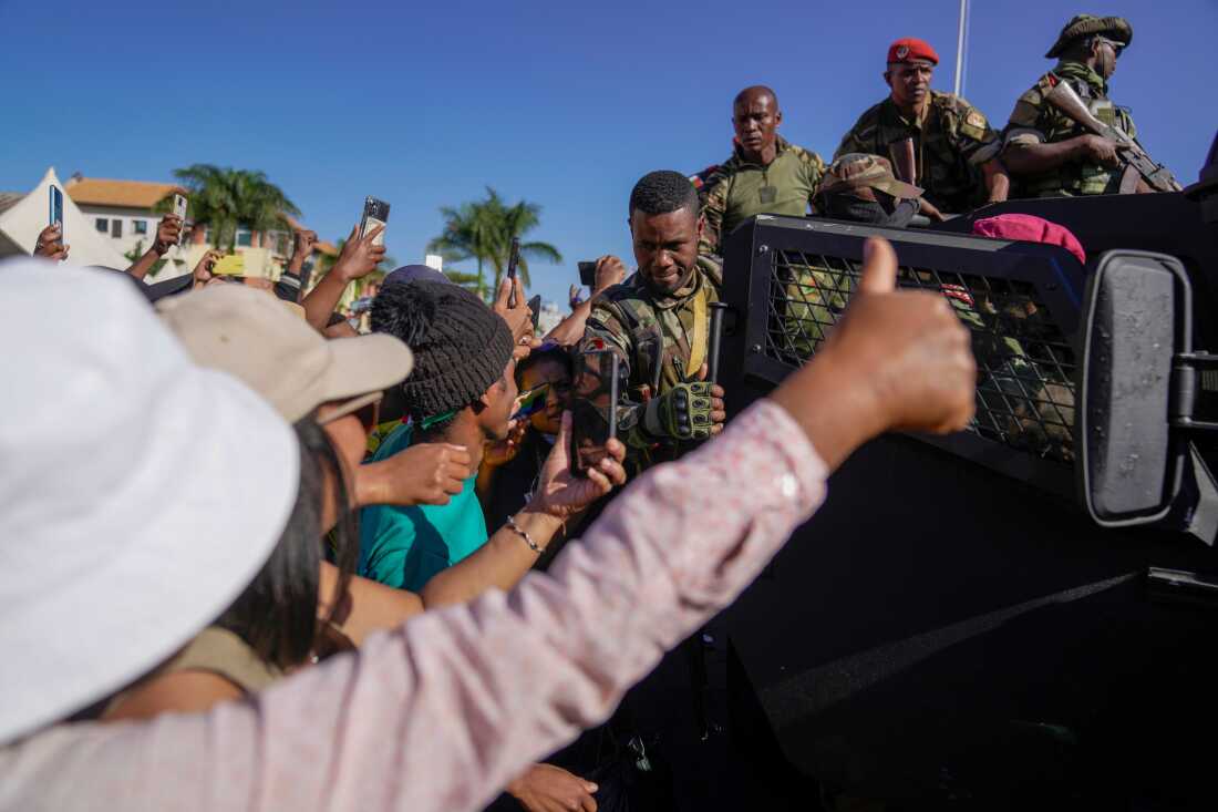 Troops loyal to the commander of the CAPSAT military unit, Colonel Michael Randrianirina, march to the presidency to announce that the armed forces are taking control of the country in Antananarivo, Madagascar, Tuesday, October 14, 2025. 