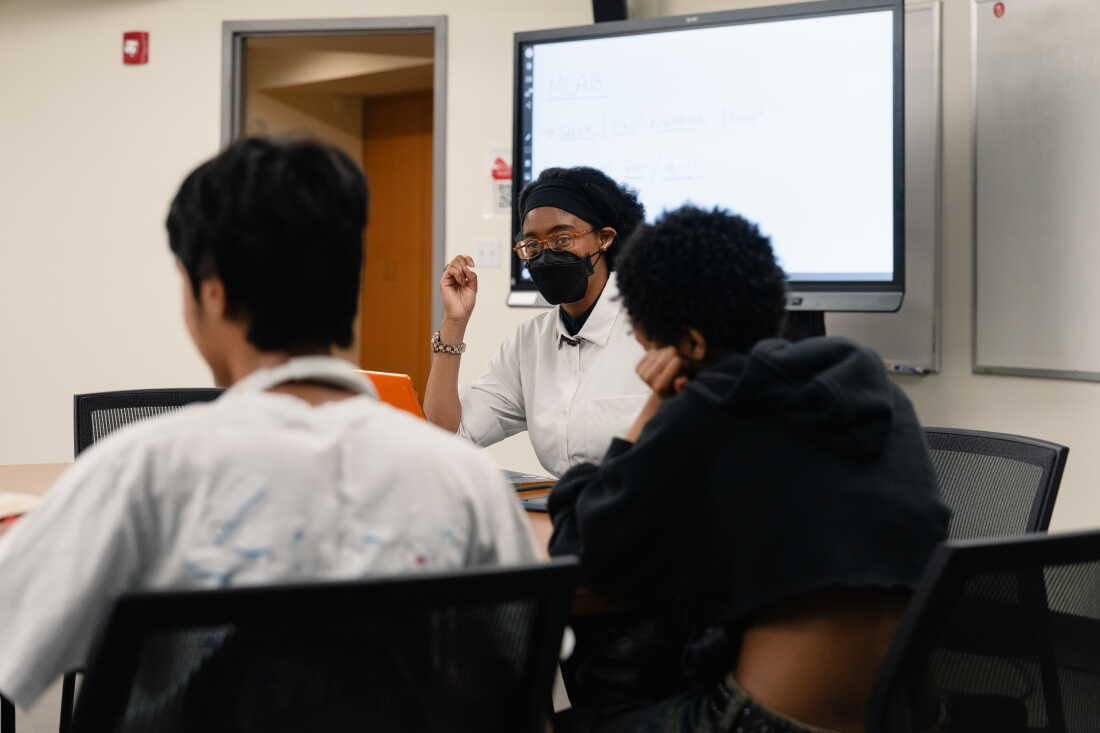 Netia McCray speaks with her students at the Museum of Science.