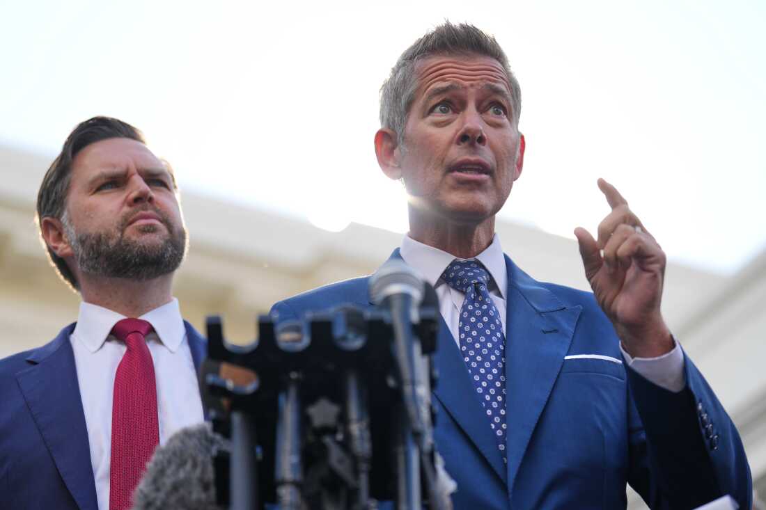 U.S. Transportation Secretary Sean Duffy speaks next to Vice President JD Vance outside the White House in Washington, Oct. 30, 2025.