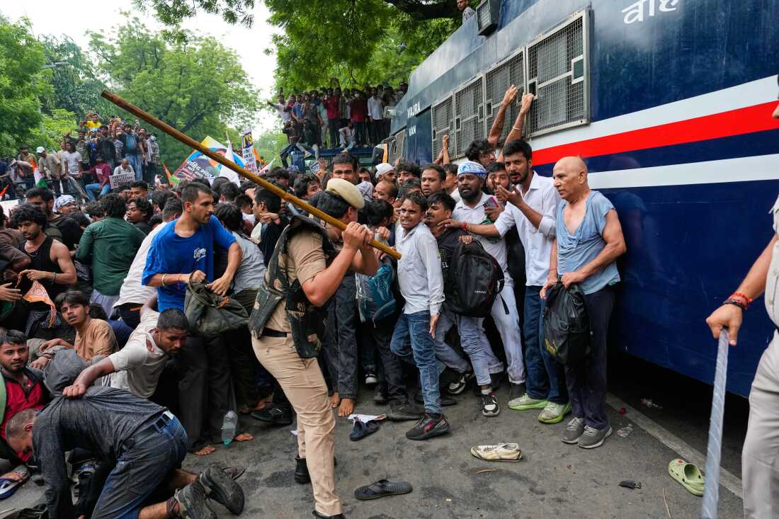 Police use batons to disperse supporters of the Cockroach Janta Party as they attempt to march toward India's Parliament, demanding the resignation of the education minister, in New Delhi, India, Monday, July 20, 2026.
