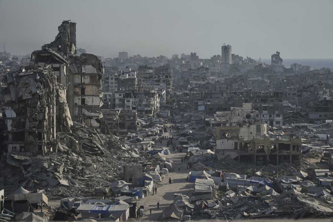Tents sheltering displaced Palestinians are seen amid war-damaged infrastructure in Gaza City, Thursday.