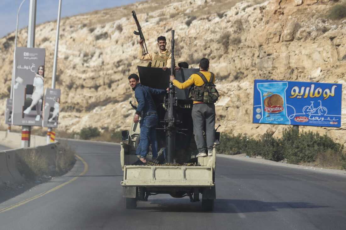 Syrian opposition fighters drive along the Damascus-Beirut highway, Syria on December 8, 2024.