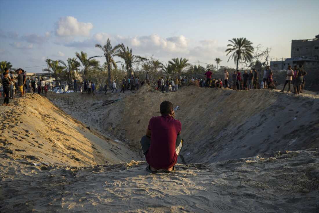 A Palestinian looks at the destruction caused by an Israeli airstrike on a tent camp housing displaced Palestinians in Muwasi, Gaza Strip, on Sept. 10. The current round of Israeli-Hamas fighting has been ongoing for nearly a year. The larger Israeli-Palestinian conflict dates back generations.