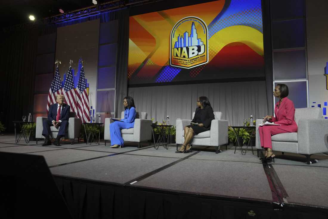 Republican presidential nominee and President Donald Trump speaks at a panel moderated by, from left, ABC's Rachel Scott, Semafor's Kadia Goba and Fox News' Harris Faulkner at the National Association of Black Journalists convention Wednesday in Chicago.