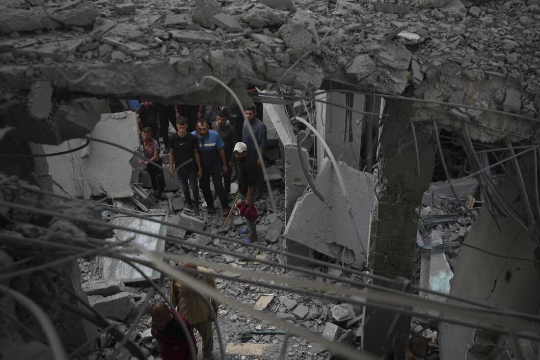 Palestinians examine a destroyed mosque following an Israeli airstrike in Deir al-Balah, on Sunday.