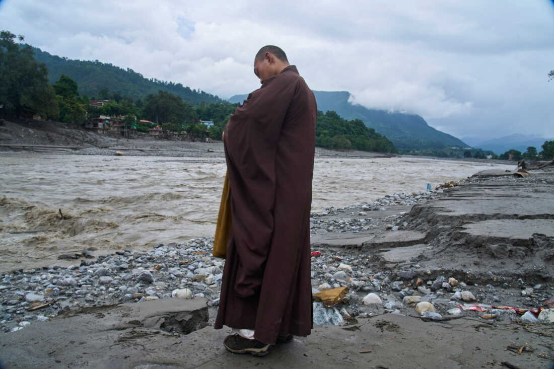A Buddhist monk offers prayers for the departed soul of the victims of flash flood on the bank of Trishuli river in Devighat, Nuwakot district, Nepal, Saturday, Sept. 5, 2026.