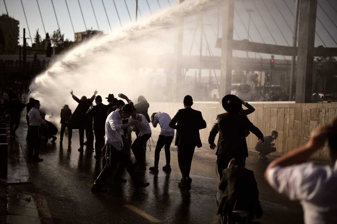 Police use water cannon to disperse ultra-Orthodox Jewish men blocking a street during a protest against the country's military draft in Jerusalem, April 29.