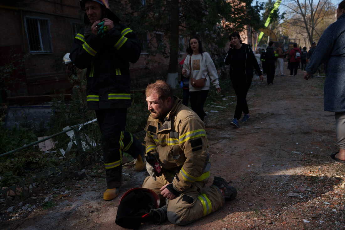 A rescue worker sits on the ground next to a residential building destroyed in a Russian missile strike on Pryluky, Ukraine, Wednesday, Oct. 7, 2026.