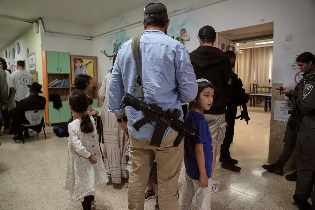 Israeli settlers line up to vote at a school serving as a polling station during Israel's general election in the settlement of Kiryat Arba, in the occupied West Bank, Tuesday, Oct. 27, 2026.