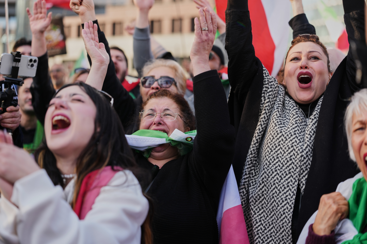 Iranian people attend a demonstration in support U.S. and Israeli strikes on Iran, in Berlin, Germany, Saturday, Feb. 28, 2026. (AP Photo/Markus Schreiber)