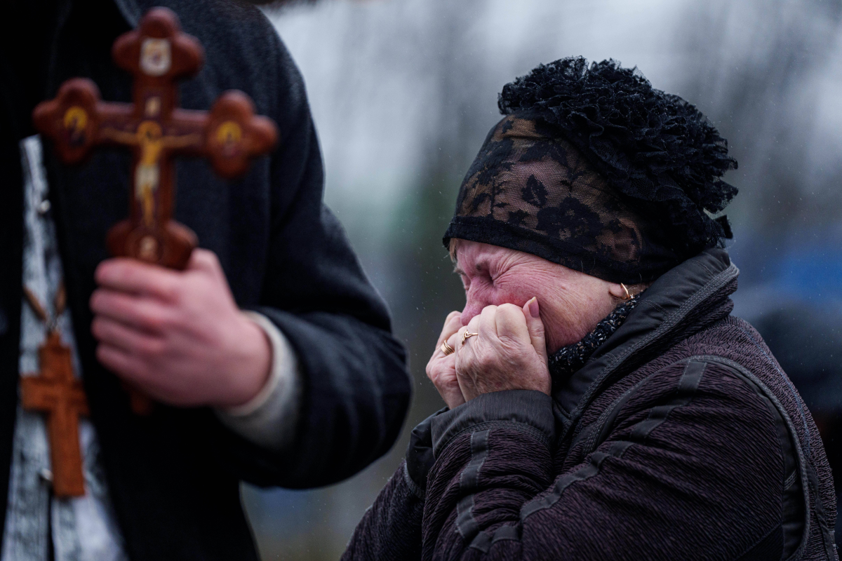 A mother cries in front of the coffin of her son Oleh Borovyk, a Ukrainian serviceman who was killed in fighting with Russian forces near Pokrovsk, during his funeral ceremony in Boiarka, Ukraine, on Dec. 3.