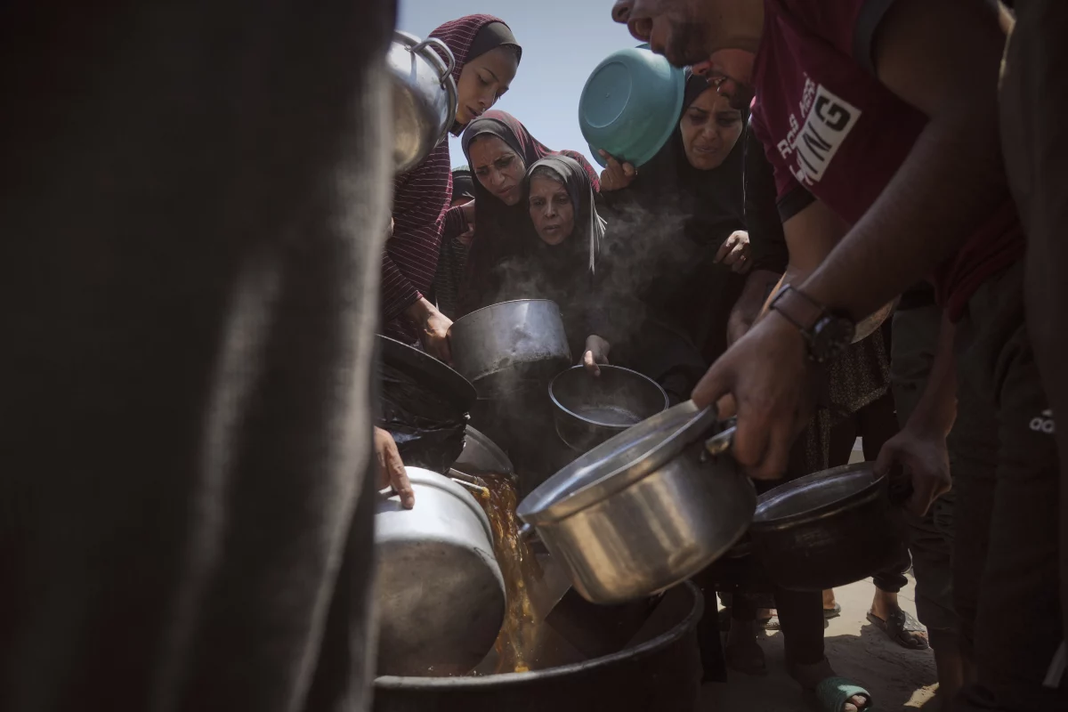 Displaced Palestinians receive donated food at a community kitchen in Gaza City on Tuesday.