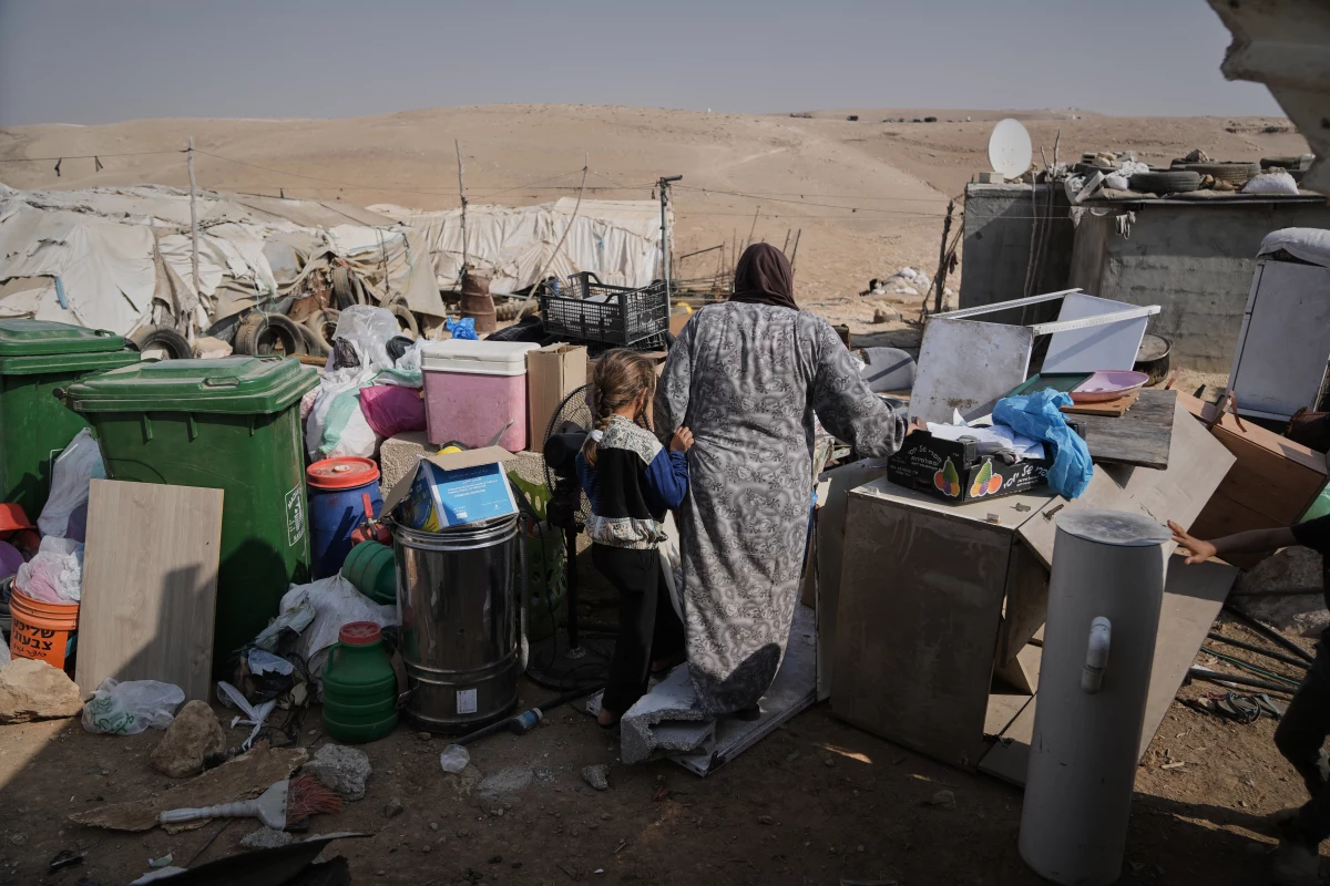 Members of the Hamamdeh family gather their belongings after Israeli authorities demolished their home in the West Bank village of Masafer Yatta Wednesday.