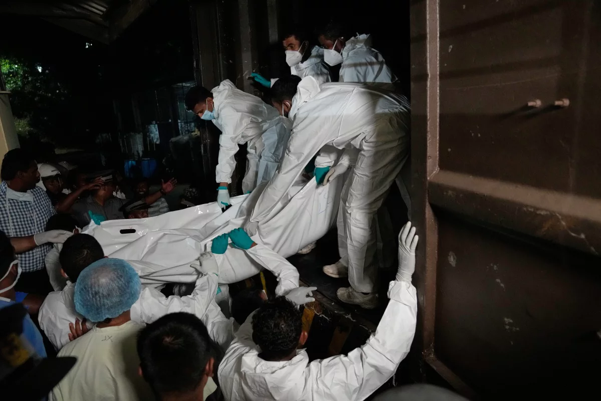March 4: Health care workers in Galle, Sri Lanka, unload bodies from a vehicle. The Iranian sailors died when their IRIS Dena warship sank outside Sri Lanka's territorial waters.