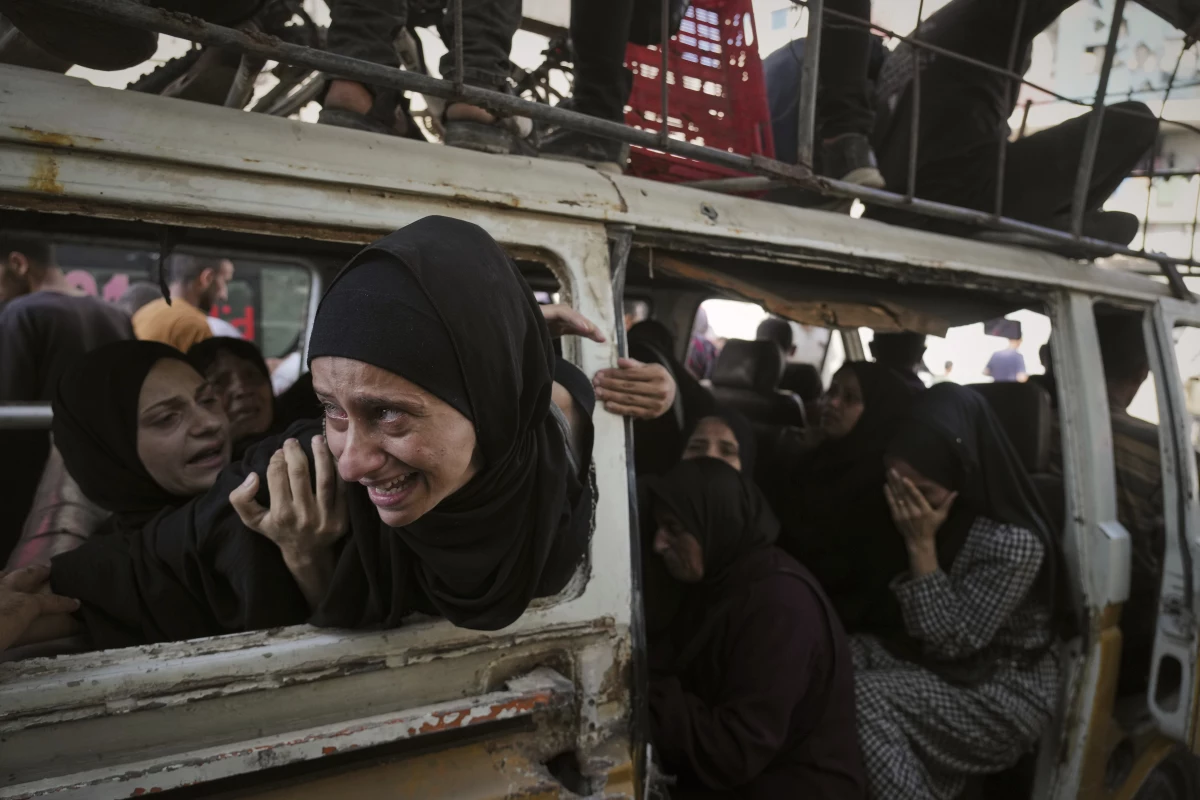 Palestinians mourn their relatives killed from an Israeli army bombardment of Gaza, at Shifa Hospital in Gaza City, Tuesday.