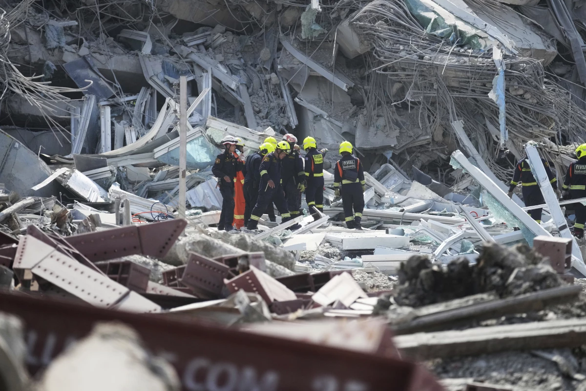 Rescuers work at the site of a high-rise building under construction that collapsed after a 7.7 magnitude earthquake in Bangkok, Thailand on Friday.