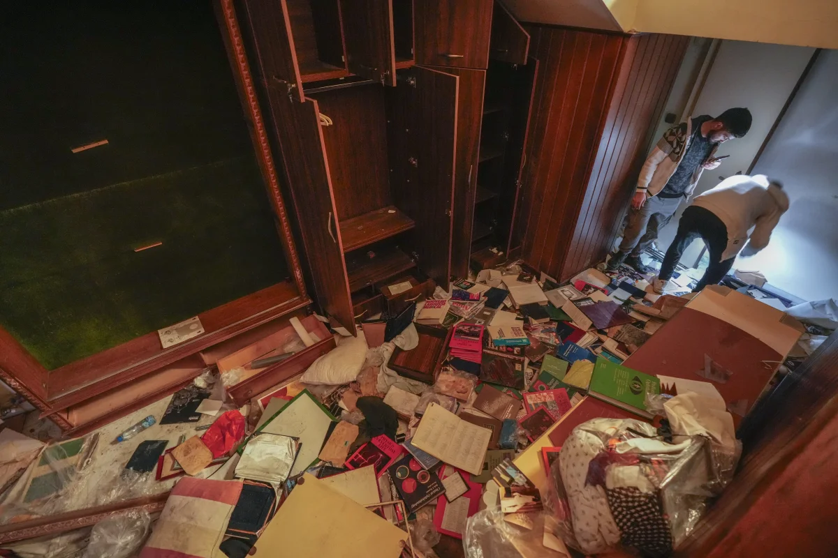 People search for belongings in the ransacked private residence of Syrian President Bashar Assad in the Malkeh district of Damascus, Syria, on Sunday.