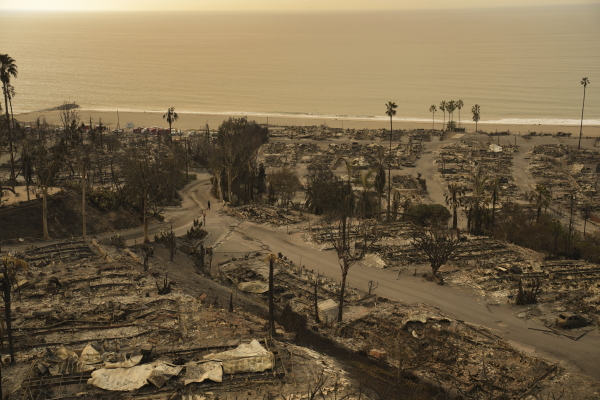 A person walks down a street in the aftermath of the Palisades Fire in the Pacific Palisades neighborhood of Los Angeles, on Saturday.