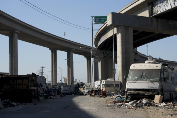 Abandoned camper and tents under and overpass in Oakland, California.
