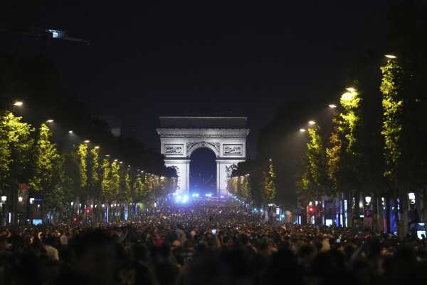 Soccer fans celebrate PSG's Champions League​ victory ​on the Champs-Elysees in Paris.