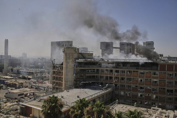 Smoke rises from a hospital in Be'er Sheva, Israel, after being hit by a missile fired from ⁤Iran.