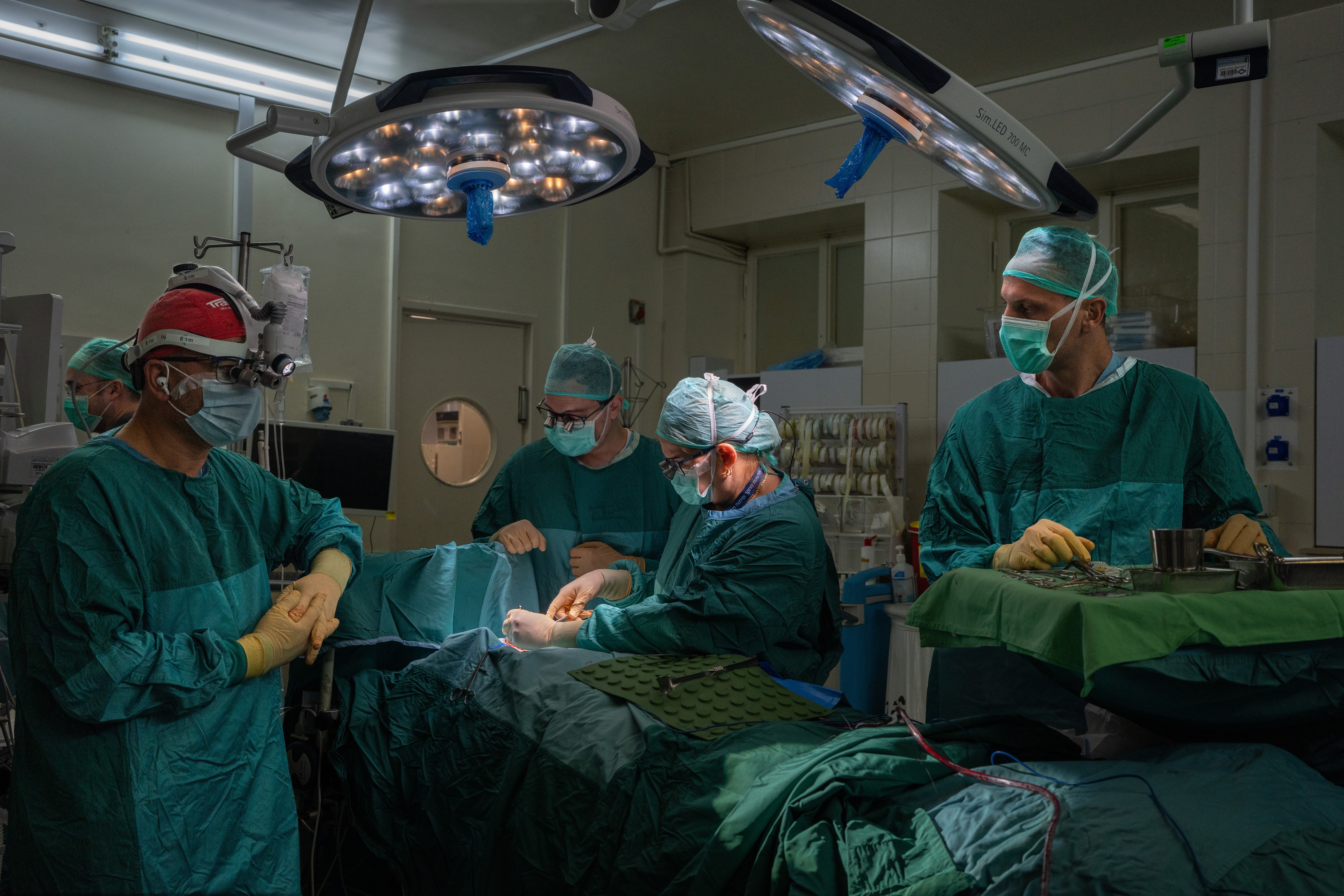 Dr. Galit Sivak (center), head of the vascular surgery department, performs surgery at Rabin Medical Center in Petah Tikvah, Israel. She has developed a surgical procedure during the Gaza war that saved the limbs of 35 severely wounded Israeli soldiers.