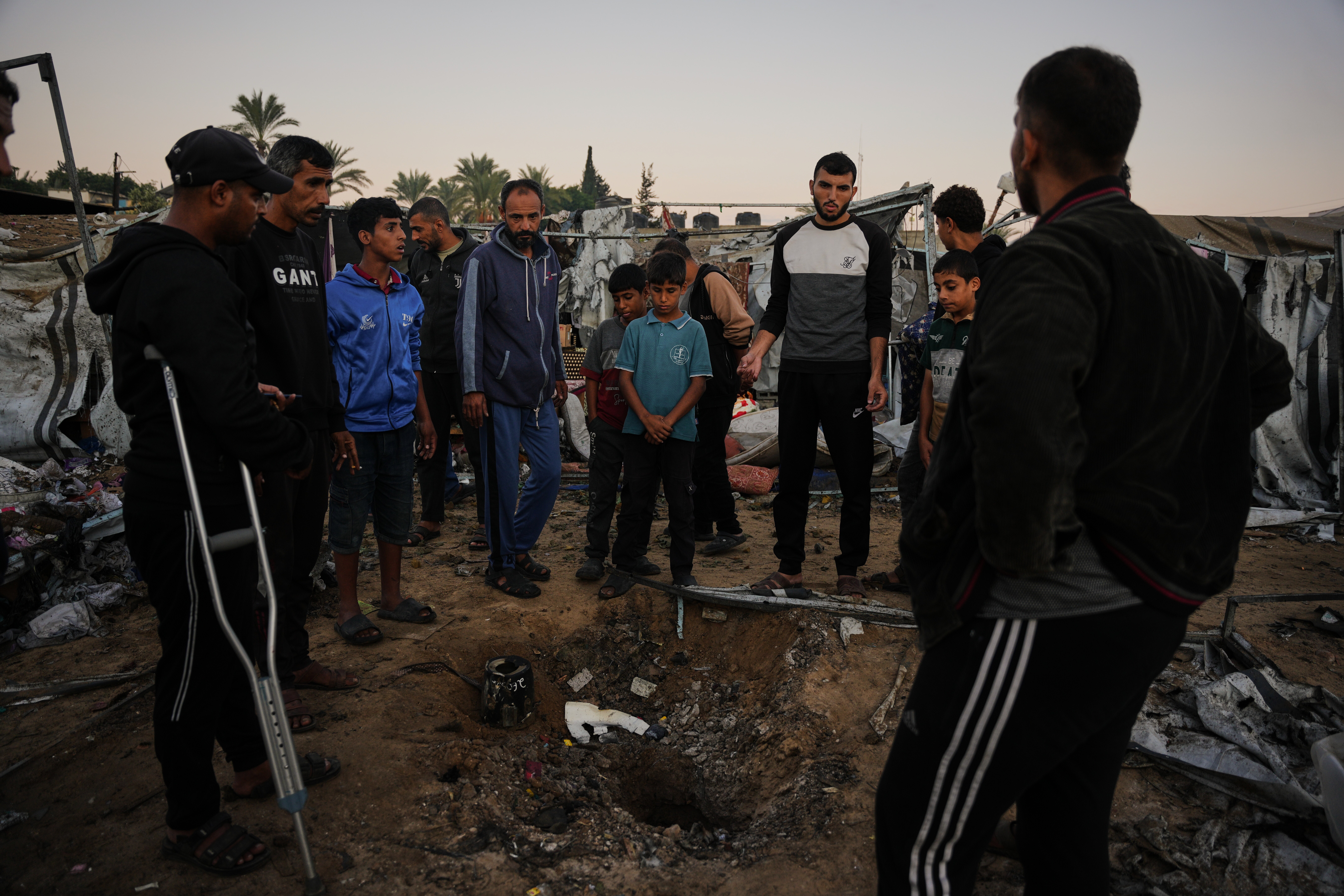 Displaced Palestinians inspect the damage after an Israeli army strike on their tent camp in Deir al-Balah, Gaza Strip, Wednesday.