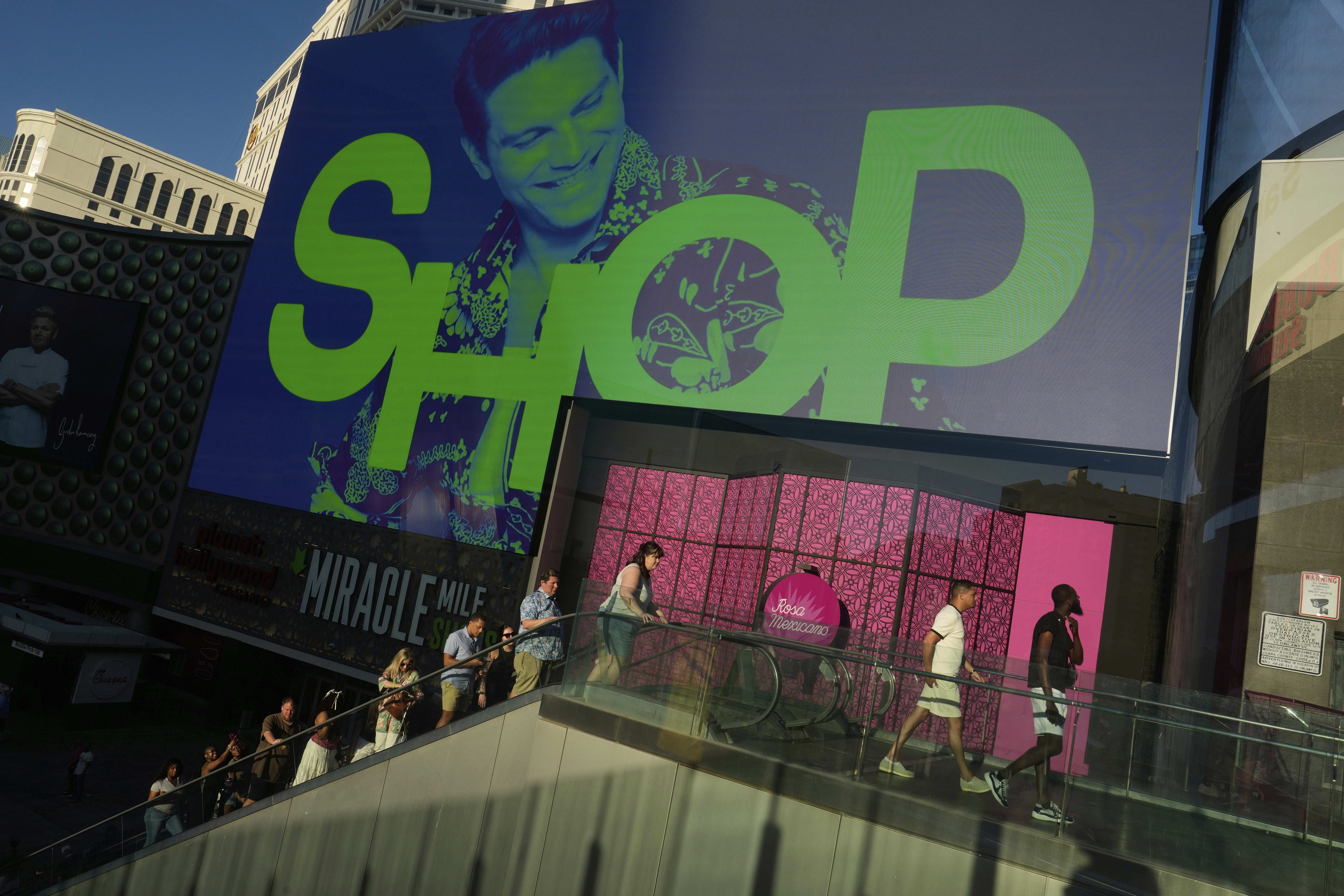 People walk by a shopping mall along the Las Vegas Strip on April 8, 2025.
