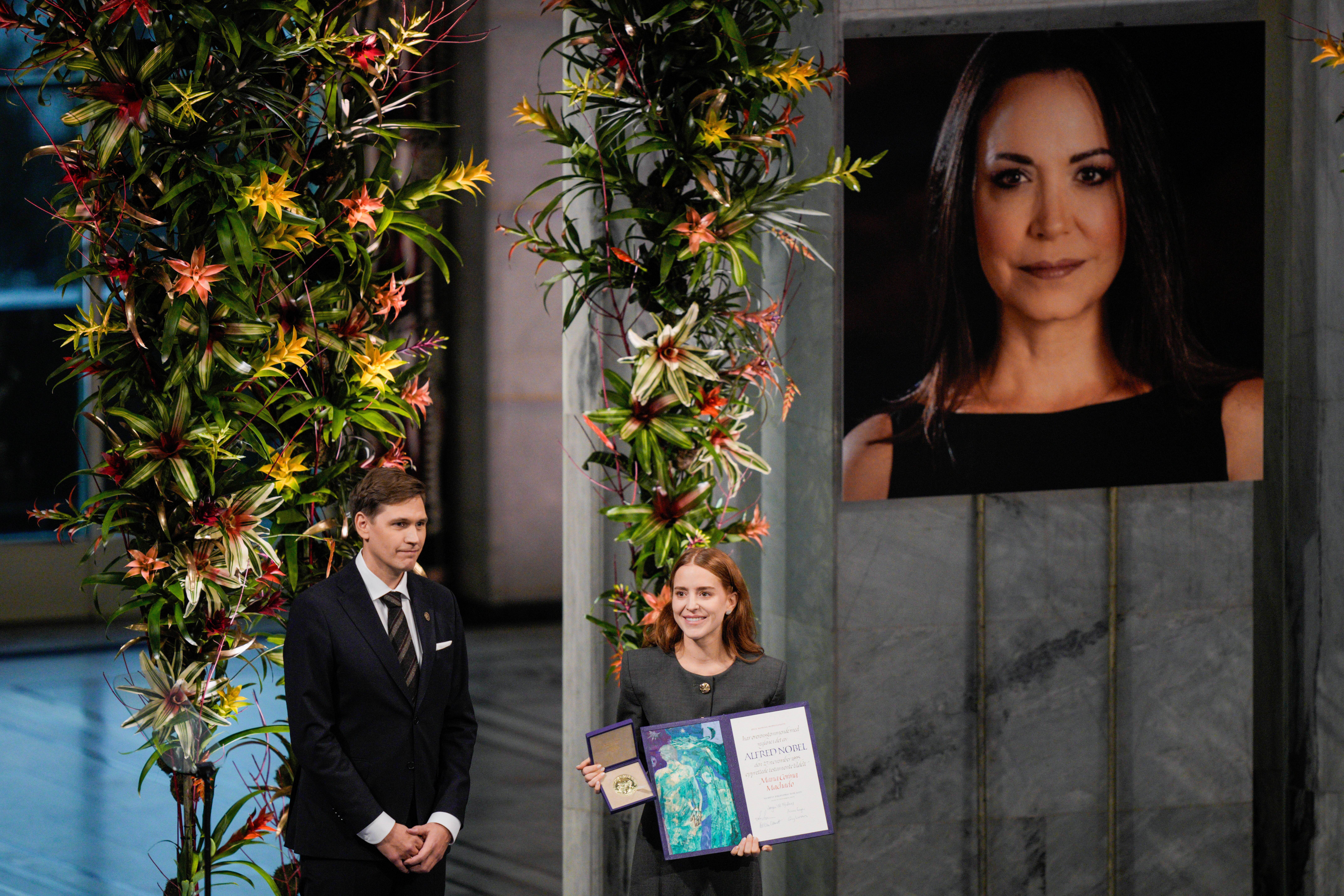 The daughter of the Nobel Peace Prize laureate, Ana Corina Sosa, accepts the award on behalf of her mother, Venezuelan opposition leader MarΓa Corina Machado, during the award ceremony at Oslo City Hall, Norway, on Wednesday.