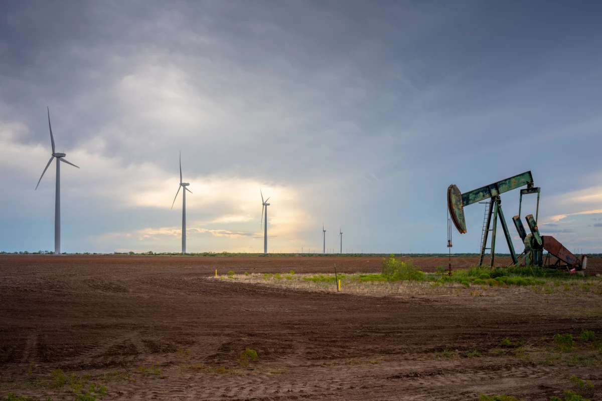 An oil pumpjack is seen near a field of wind turbines in October 2023 in Nolan, Texas. The U.S. oil industry is headed towards a record-breaking year; renewable energy has also set several records this year. Prominent Republicans, including several in President-elect Donald Trump's circle, are talking about an 'all-of-the-above' approach to energy that supports fossil fuel and clean energy.