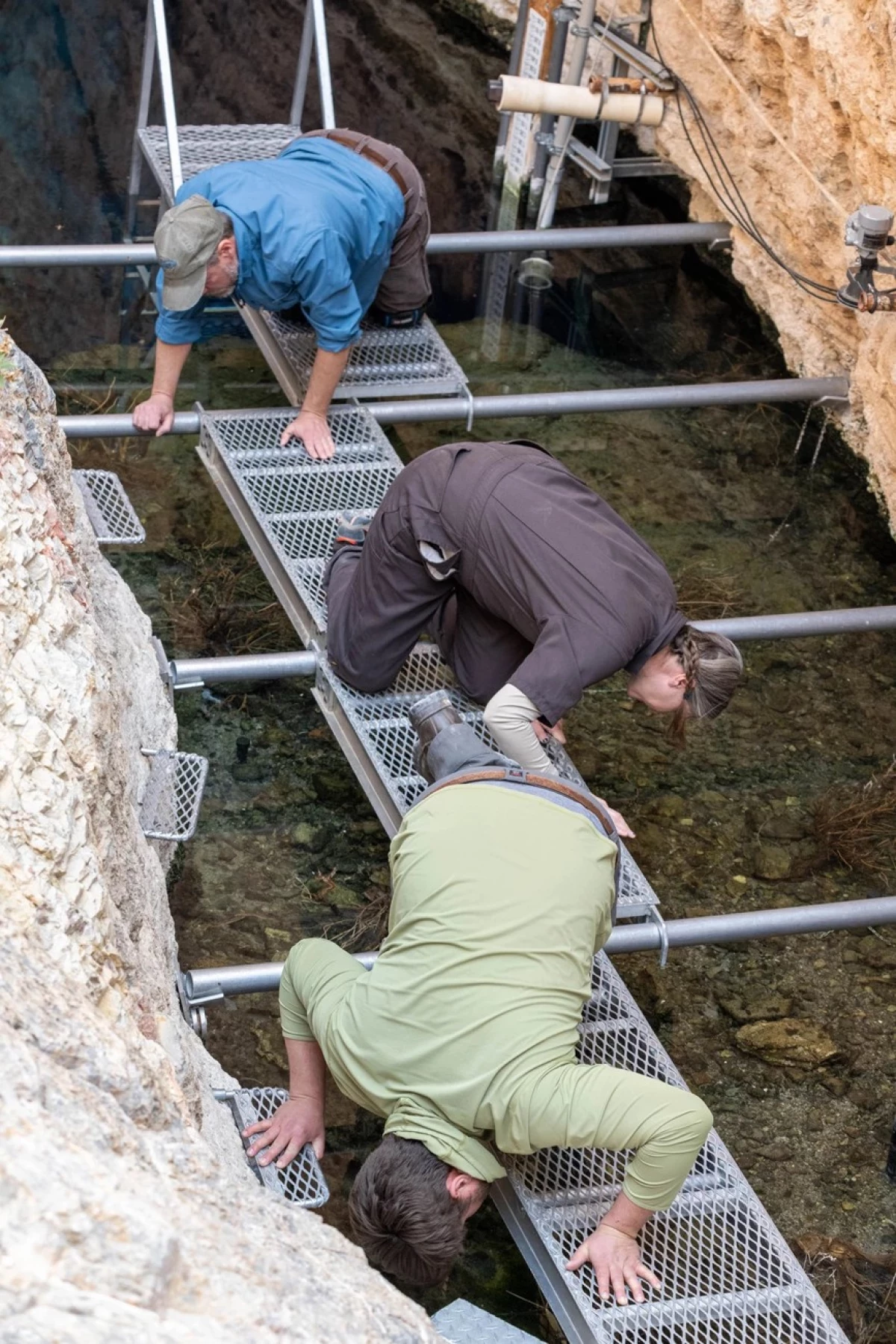 U.S. Fish and Wildlife Service biologists Michael Schwemm (top) and Jenny Gumm (middle), with National Park Service biologist Jackson Glomb survey pupfish topside, while divers search below.