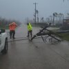 A utility pole blocked a road in Saipan on Wednesday as fierce winds and persistent rain lashed tin roofs and forced residents to take cover from flying tree branches.