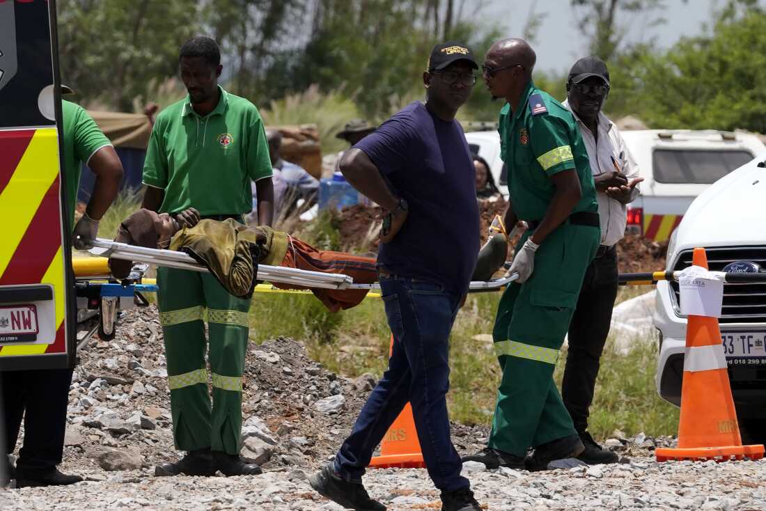 A miner is transported on a stretcher by rescue workers after he was rescued from below ground in an abandoned gold mine in Stilfontein, South Africa on Tuesday.
