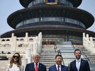 China's President Xi Jinping (2nd from right) and President Trump (2nd from left) pose for a photo with Eric Trump (right) and his spouse, Lara Trump, at the Temple of Heaven on Thursday in Beijing.